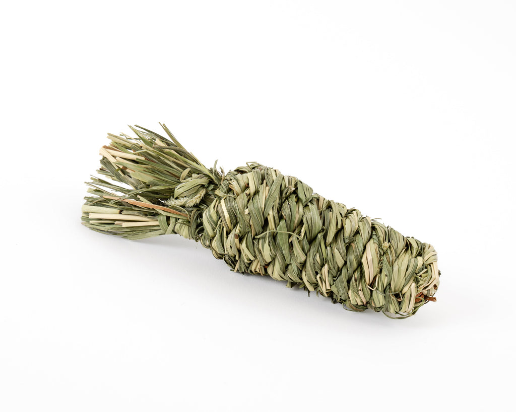Dried timothy grass chew toy in shape of a carrot, photographed on a clean white background
