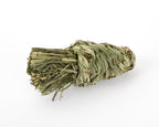 Dried timothy grass chew toy in shape of a carrot, photographed on a clean white background