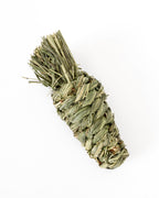 Dried timothy grass chew toy in shape of a carrot, photographed on a clean white background