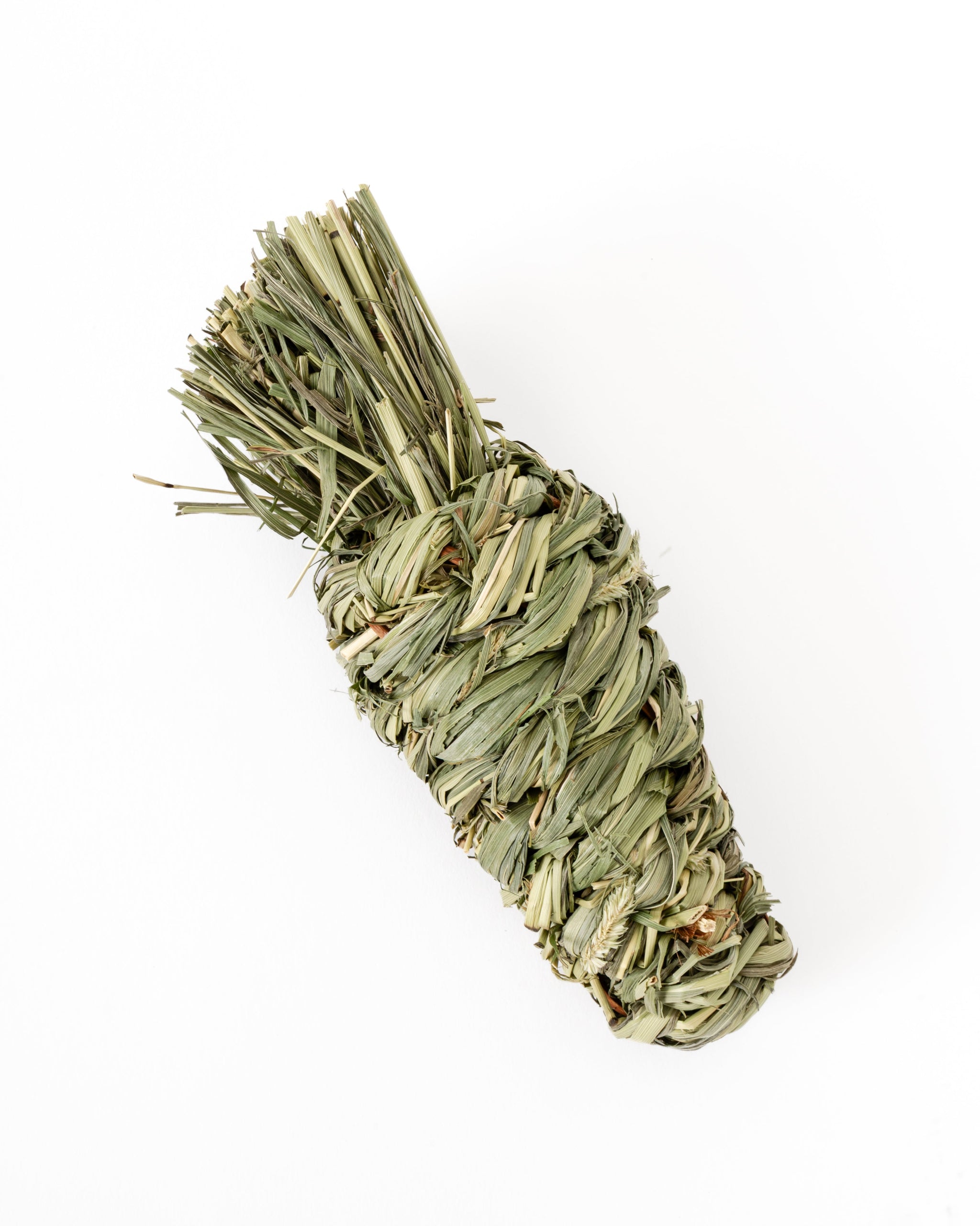 Dried timothy grass chew toy in shape of a carrot, photographed on a clean white background
