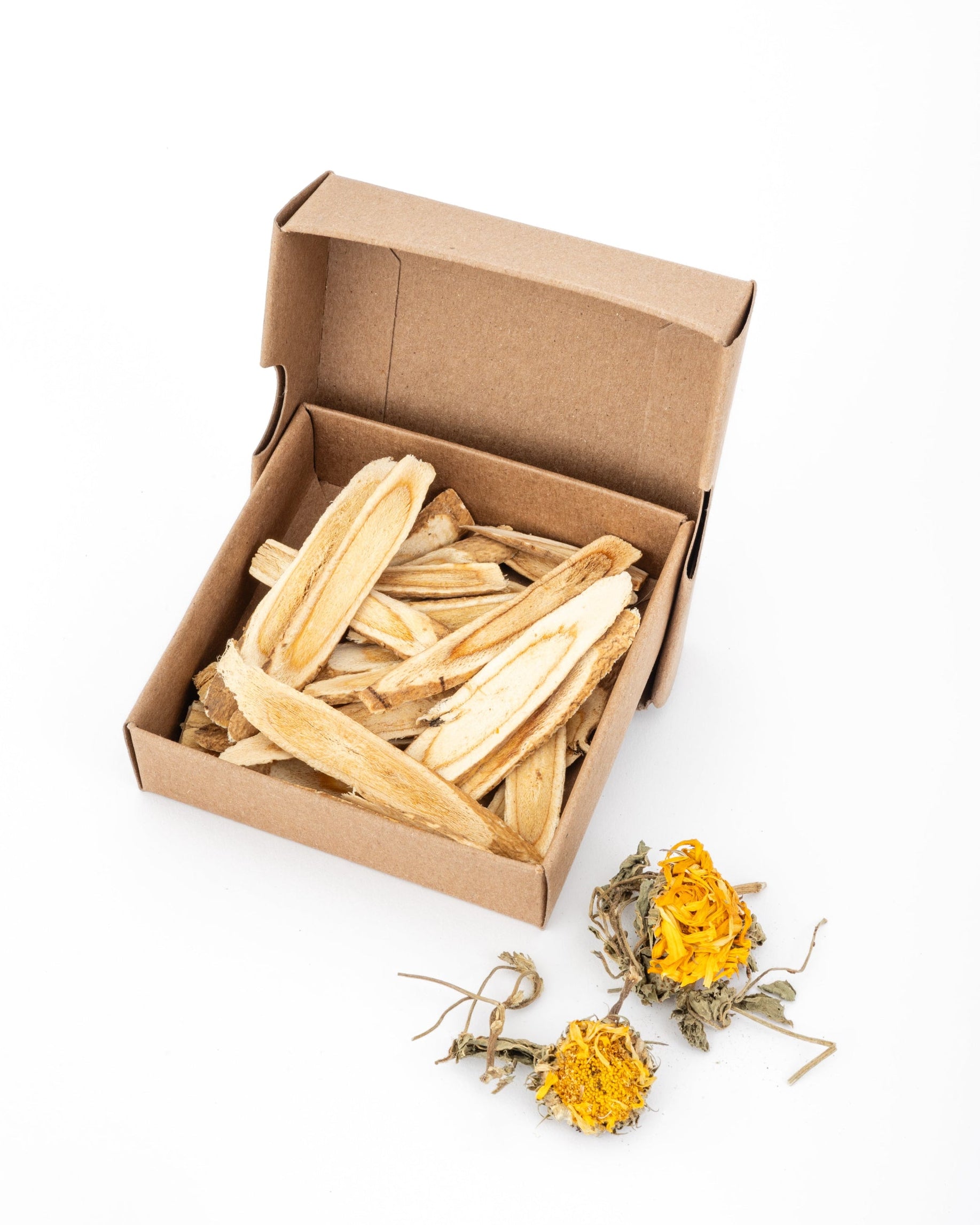 box of dried astragulus root with calendula blossoms as on the side as decoration