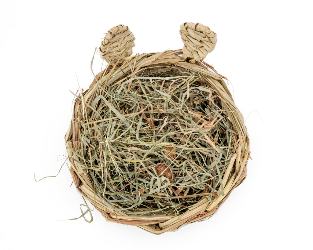 hand woven reed basket with bunny ears filled with hay