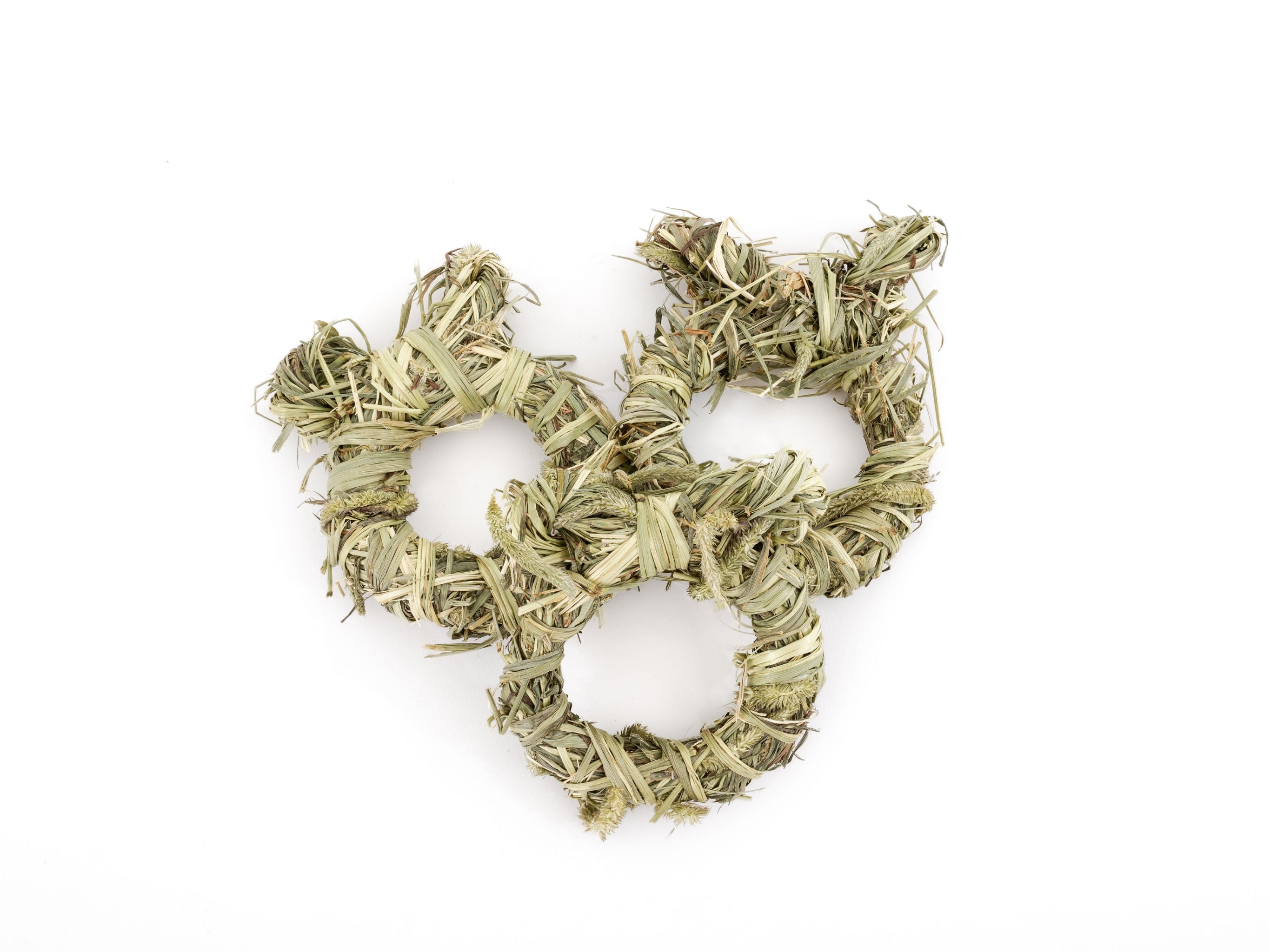 Three hay wreaths on a white background