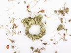 Clover Days timothy hay rings with bunny ears on a scattered herb background