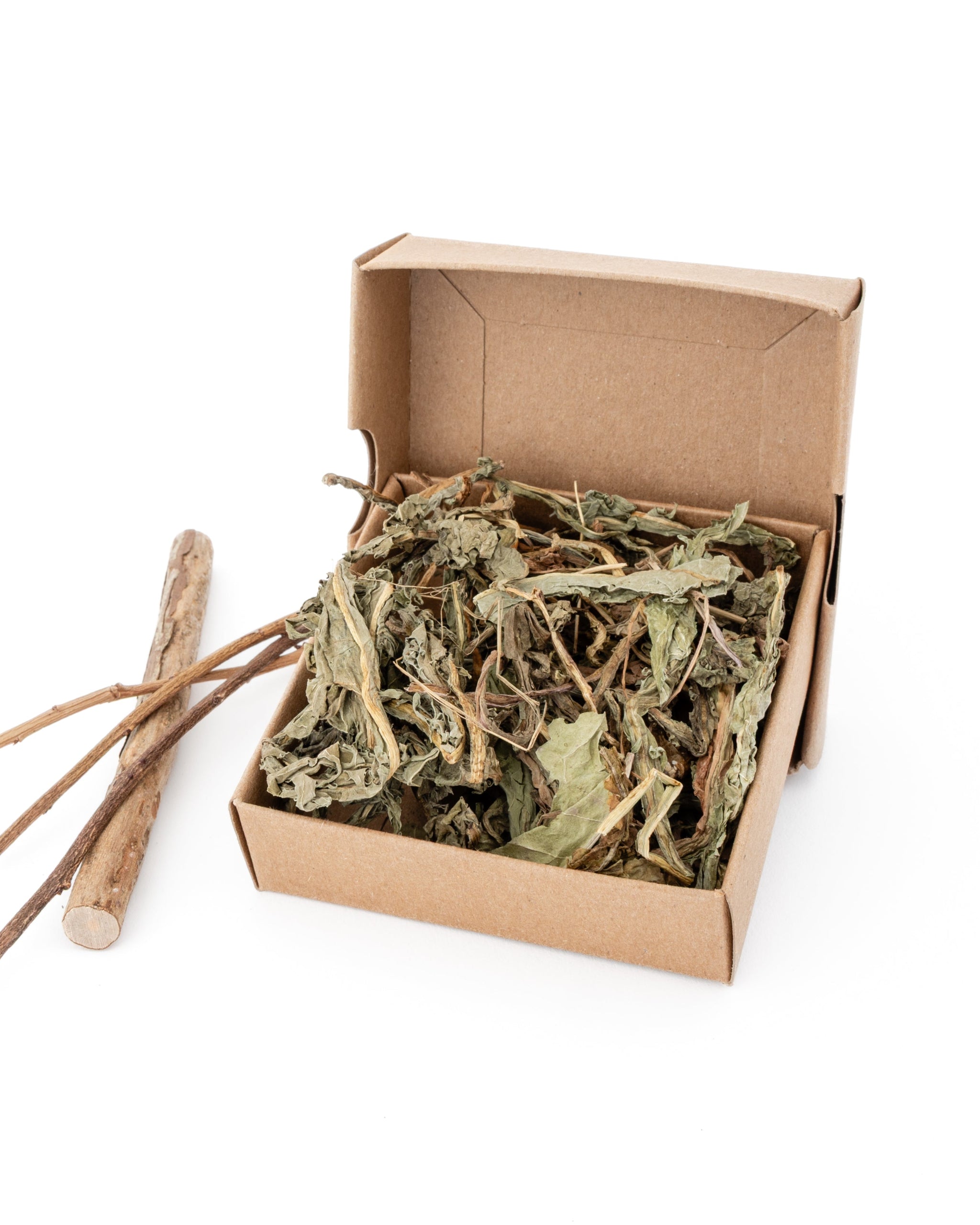 box of dried dandelion leaf with blueberry sticks on the side as decoration